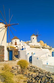 Images Dated 31st August 2021: The white buildings and the windmills on the mountain cliffs of Oia, Santorini, Greece
