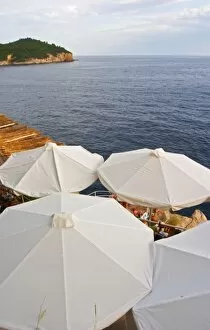 Images Dated 7th July 2006: White sun shade umbrellas at a cafe on the city wall overlooking the sea and the