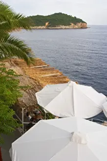 Brasserie Prints: White sun shade umbrellas at a cafe on the city wall overlooking the sea