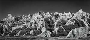 Prints of The wind and water eroded landscape in the Badlands National Park seem desolate but make for beautiful natural carvings. USA Images Dated 2024 November: The wind and water eroded landscape in the Badlands National Park seem desolate but make for beautiful natural carvings