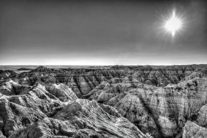 Prints of The wind and water eroded landscape in the Badlands National Park seem desolate but make for beautiful natural carvings. USA Images Dated 2024 November: The wind and water eroded landscape in the Badlands National Park seem desolate but make for beautiful natural carvings