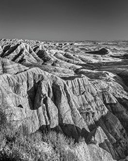 Prints of The wind and water eroded landscape in the Badlands National Park seem desolate but make for beautiful natural carvings. USA Images Dated 2024 November: The wind and water eroded landscape in the Badlands National Park seem desolate but make for beautiful natural carvings