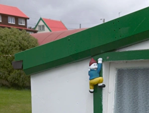 Images Dated 10th September 2009: Window decorated with a little climbing figure, Port Stanley, Falkland Islands