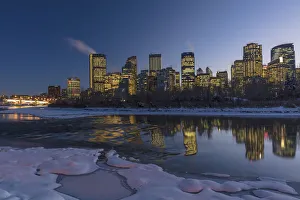 Downtown Prints: Winter city skyline reflects in the Bow River in Calgary, Alberta, Canada