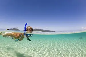 Snorkeling Prints: woman (age 23) enjoying snorkeling the clear tropical waters of a remote island