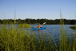 Images Dated 17th August 2006: A woman kayaks in the Black Hall River near the mouth of the Connecticut River in Old Lyme
