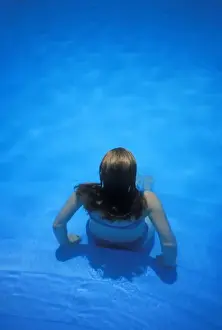 Adventure Prints: Woman sitting on edge of pool, Manuel Antonia National Park, Costa Rica, MR