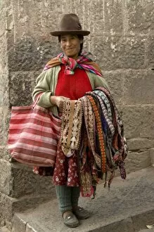 Woman with weavings to sell, Cuzco, Peru. (MR)