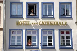 Women looking out the window of the Cathedral Hotel at Strasbourg, France