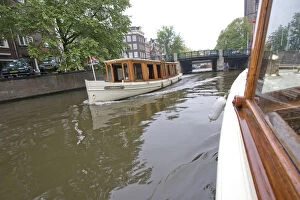 Images Dated 6th September 2007: Wood panaled boats pass eachother on a canal near a bridge