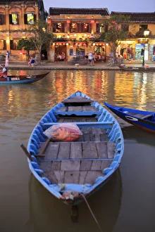 Prints of Wooden boats moored on the Thu Bon River opposite Bach Dang Street in the old town of Hoi An, Vietnam Images Dated 2017 December: Wooden boats moored on the Thu Bon River opposite Bach Dang Street in the old town of Hoi An