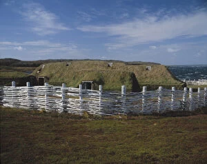 Wooden fence around sod buildings in L Anse aux Meadows Nat l Historic Site