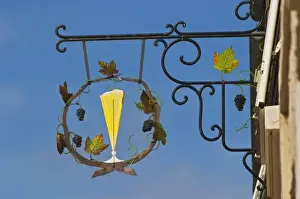 Illustrate Prints: A wrought iron sign that illustrates the theme of champagne and wine production