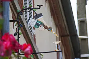 Images Dated 10th August 2015: A wrouight iron painted sign that illustrates the theme of champagne and wine production