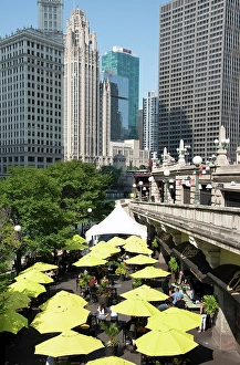 Path Prints: Yellow umbrellas at cafe at Riverwalk along the Chicago River in downtown Chicago