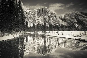 Snowy Prints: Yosemite Falls above the Merced River in winter, Yosemite National Park, California USA