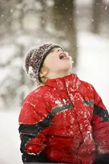 Coat Prints: A young boy catches snowflakes with his mouth during a snowstorm in Portsmouth