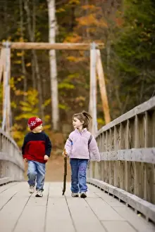 Innocent Prints: A young brother and sister (ages 4 and 6) hike on a suspension bridge in New Hampshire s