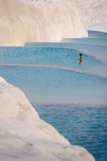 Travertine Prints: Young girl on travertine terraces of Pamukkale, Turkey