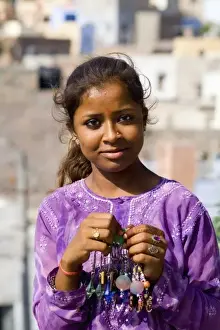 Population Prints: Young Indian girl aged 15 in purple in front of village of Jodhpur in Rajasthan India