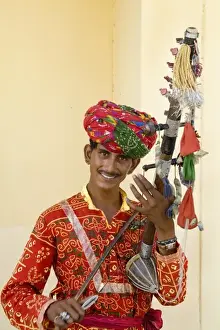 Musical Instrument Prints: Young man in traditional costume playing old fashioned guitar instrument called a