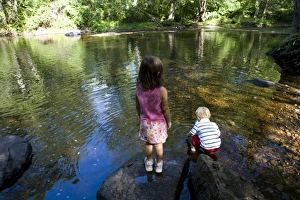 Holding Prints: Young siblings play in the Eightmile River in Lyme, Connecticut. The Nature Conservancy s